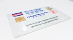 A close-up view of a transparent identification card featuring various logos and text.